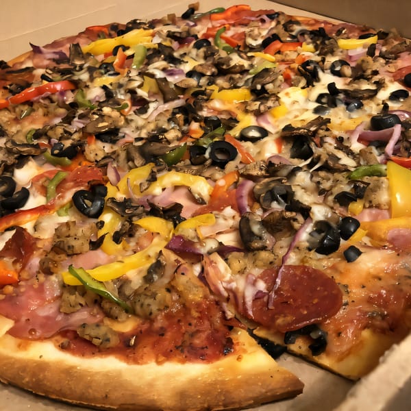 A Palio's Pizza Cafe Grapevine pizza with various toppings, including pepperoni, olives, and bell peppers.